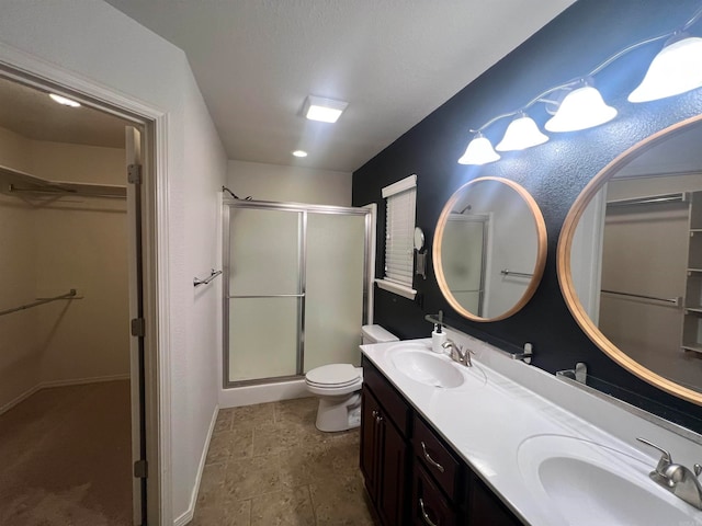 bathroom with vanity, an enclosed shower, and toilet