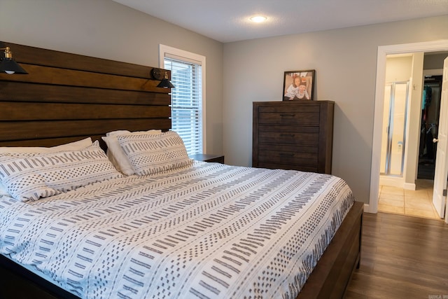 bedroom featuring a textured ceiling and dark hardwood / wood-style floors