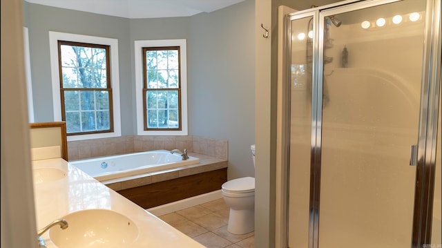 full bathroom featuring toilet, vanity, tile patterned floors, and separate shower and tub