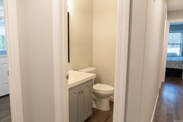 bathroom featuring vanity, hardwood / wood-style floors, and toilet