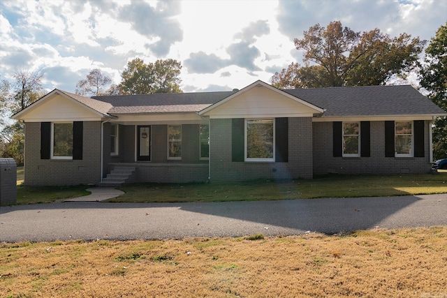 ranch-style home with a front lawn