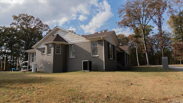 view of property exterior featuring central AC and a lawn