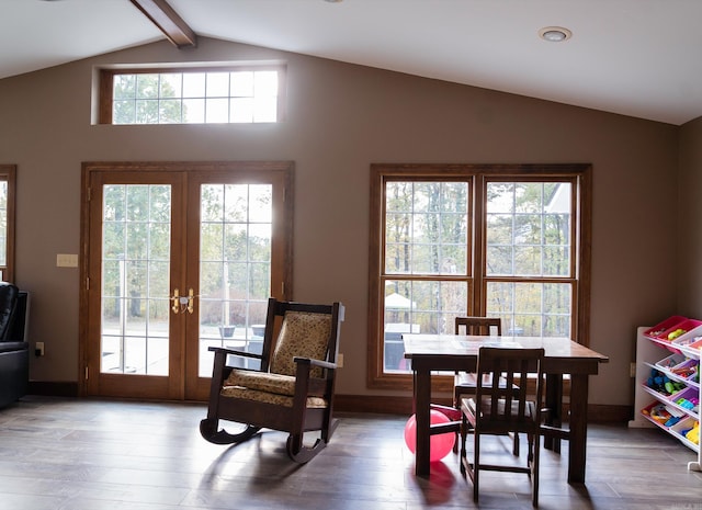 dining area with french doors, wood-type flooring, and vaulted ceiling with beams