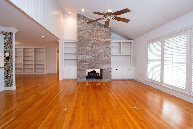 unfurnished living room with light hardwood / wood-style floors, high vaulted ceiling, a fireplace, and ceiling fan