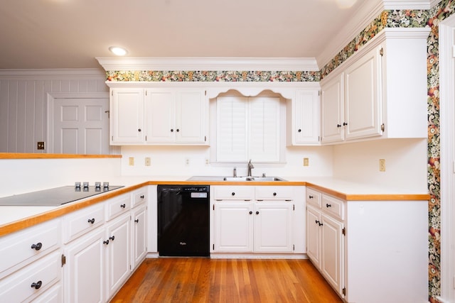 kitchen with white cabinetry, black appliances, and sink