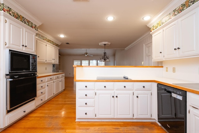 kitchen featuring white cabinetry, black appliances, and hanging light fixtures