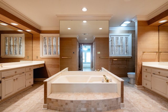 bathroom with vanity, toilet, crown molding, and tiled tub