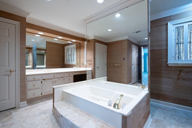 bathroom featuring vanity, ornamental molding, and a relaxing tiled tub