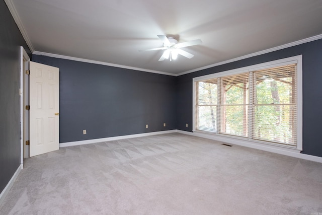 carpeted spare room with crown molding and ceiling fan