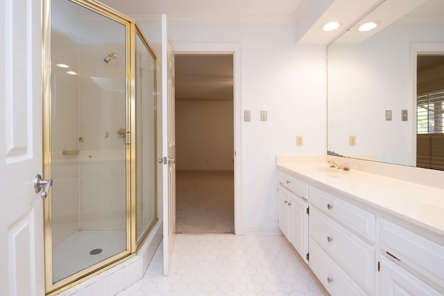 bathroom featuring a shower with door, vanity, and crown molding