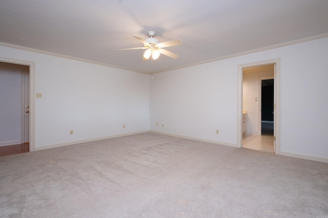 carpeted spare room with ornamental molding and ceiling fan