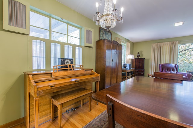 interior space featuring a notable chandelier, wood-type flooring, and a wealth of natural light