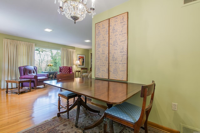 dining room with a notable chandelier and hardwood / wood-style flooring