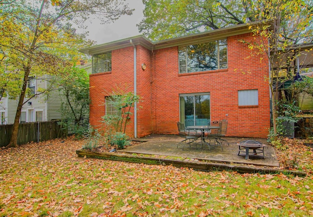 rear view of house with an outdoor fire pit and a patio area