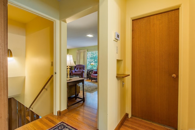 corridor with wood-type flooring