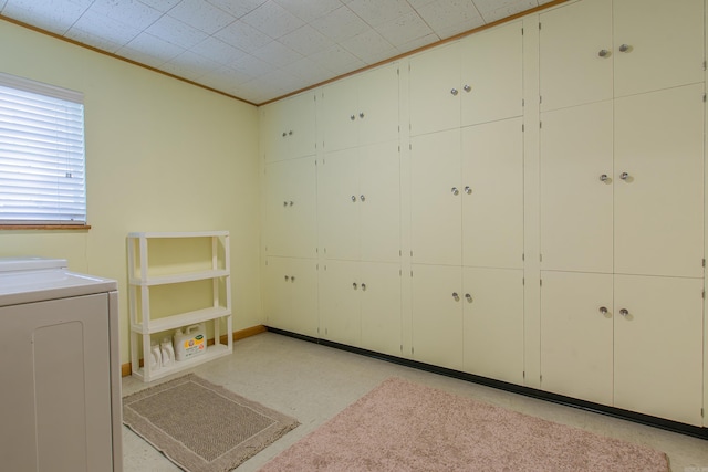 washroom with washer / dryer and cabinets