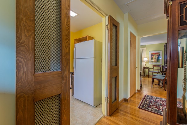 corridor with light hardwood / wood-style flooring