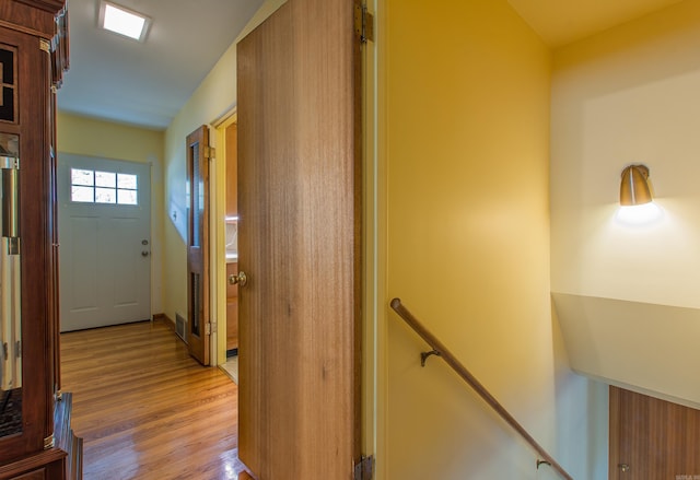 corridor with light hardwood / wood-style flooring