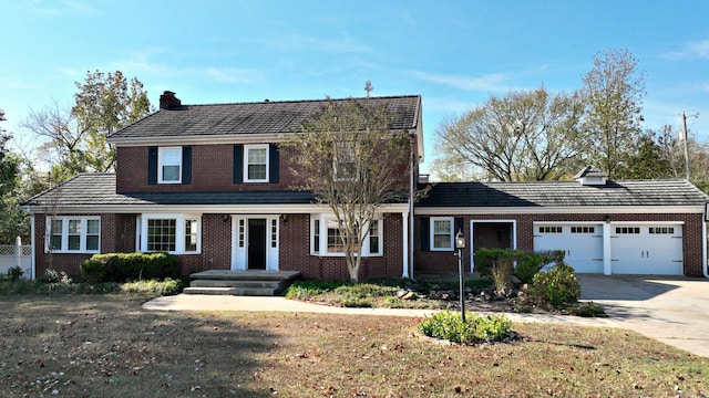301 Reine St, Mena, AR 71953 - view of front of home featuring an attached garage, a chimney, and brick siding