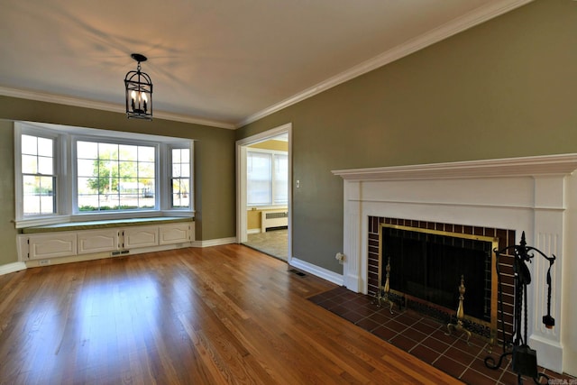 unfurnished living room with ornamental molding, radiator heating unit, a brick fireplace, and dark hardwood / wood-style flooring