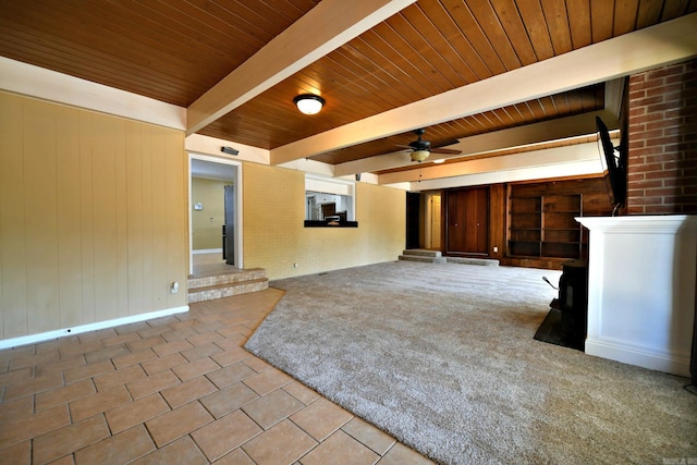 unfurnished living room with wood ceiling, beamed ceiling, light tile patterned floors, and ceiling fan