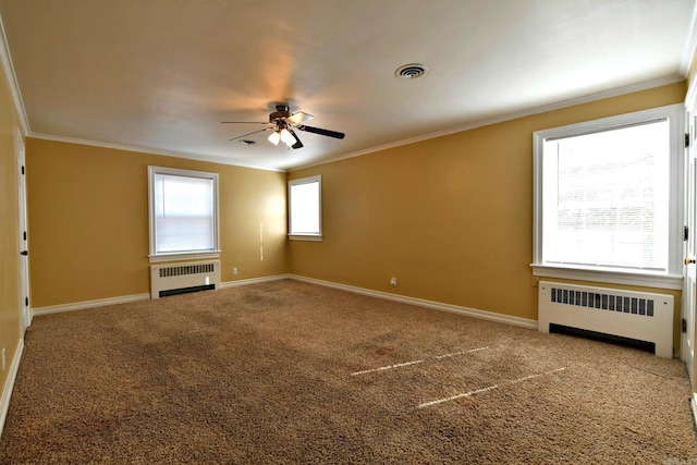 301 Reine St, Mena, AR 71953 - carpeted spare room featuring radiator heating unit, crown molding, a ceiling fan, and visible vents