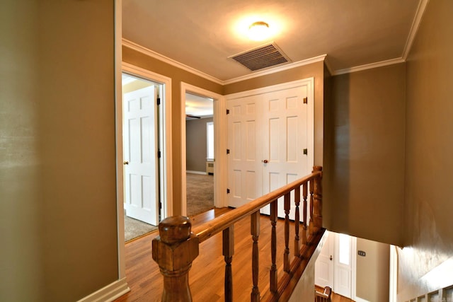 stairs with crown molding and hardwood / wood-style floors