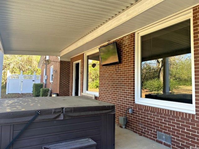 301 Reine St, Mena, AR 71953 - view of patio featuring a hot tub, fence, and visible vents
