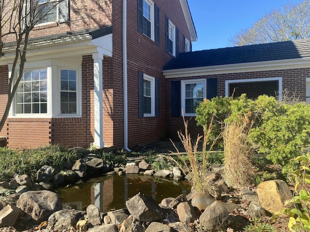301 Reine St, Mena, AR 71953 - view of property exterior featuring a small pond and brick siding