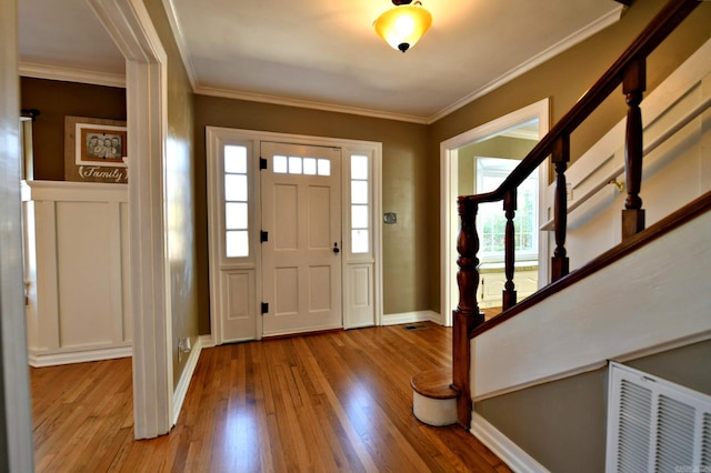 301 Reine St, Mena, AR 71953 - foyer featuring visible vents, crown molding, stairs, wood finished floors, and baseboards