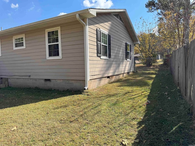 view of side of property with a yard