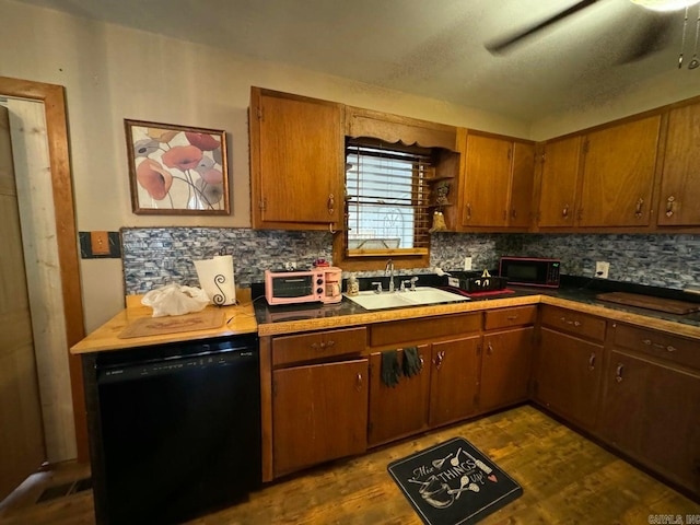 kitchen with backsplash, black appliances, sink, and dark hardwood / wood-style flooring