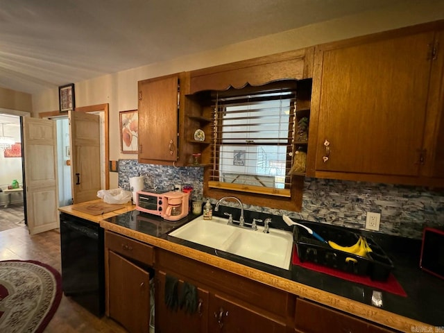 kitchen featuring black dishwasher, tasteful backsplash, sink, and tile patterned flooring