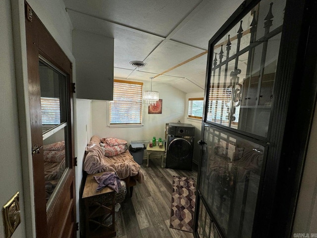 interior space with hardwood / wood-style flooring and vaulted ceiling