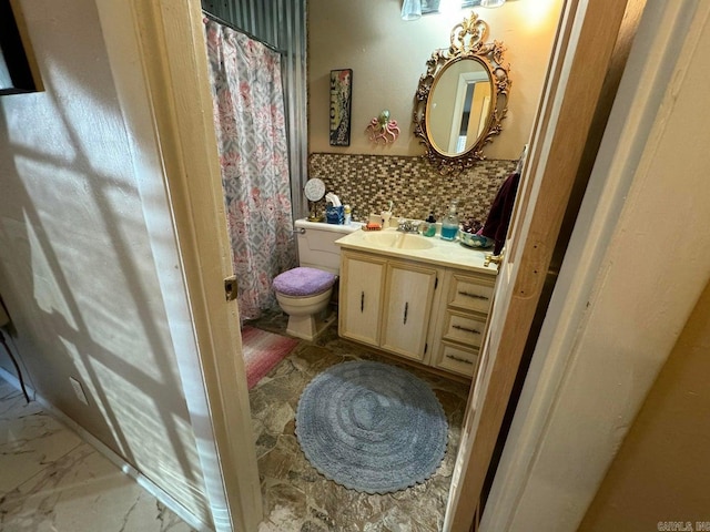 bathroom featuring vanity, walk in shower, toilet, and backsplash