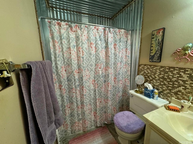 bathroom featuring backsplash, vanity, a shower with shower curtain, and toilet