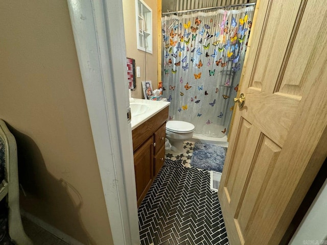 bathroom featuring vanity, curtained shower, toilet, and tile patterned flooring