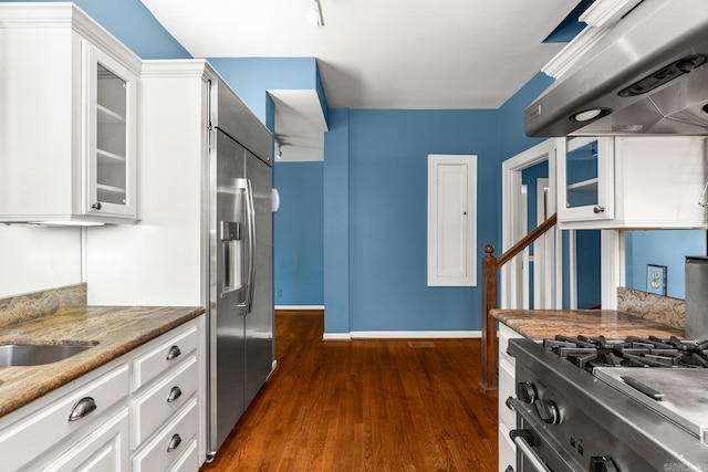 kitchen with stainless steel appliances, exhaust hood, dark hardwood / wood-style flooring, and white cabinets