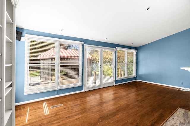 unfurnished room with wood-type flooring