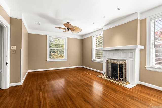 unfurnished living room featuring hardwood / wood-style floors, ceiling fan, and plenty of natural light