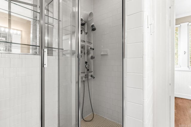 bathroom featuring hardwood / wood-style flooring and walk in shower