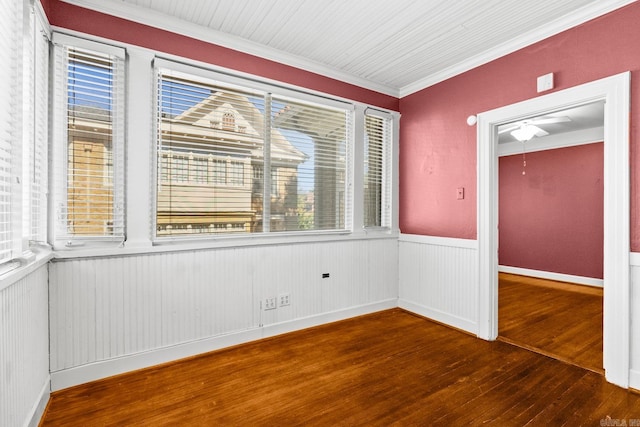 empty room featuring crown molding and hardwood / wood-style flooring