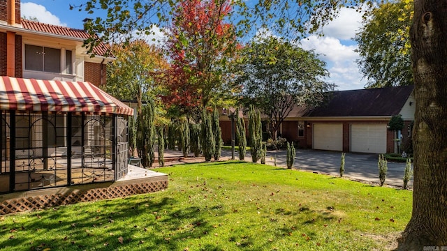 view of yard with a wooden deck and a garage