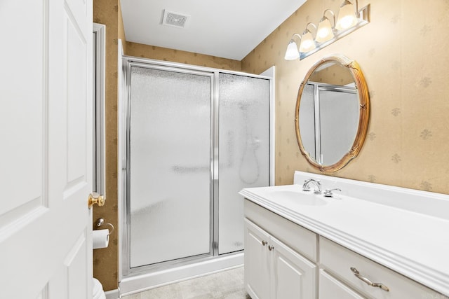 bathroom with vanity, toilet, and walk in shower