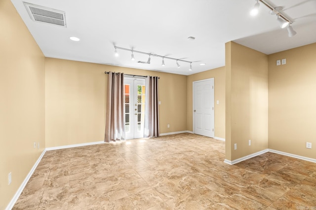 unfurnished room with french doors and rail lighting