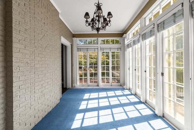 unfurnished sunroom with a chandelier and plenty of natural light