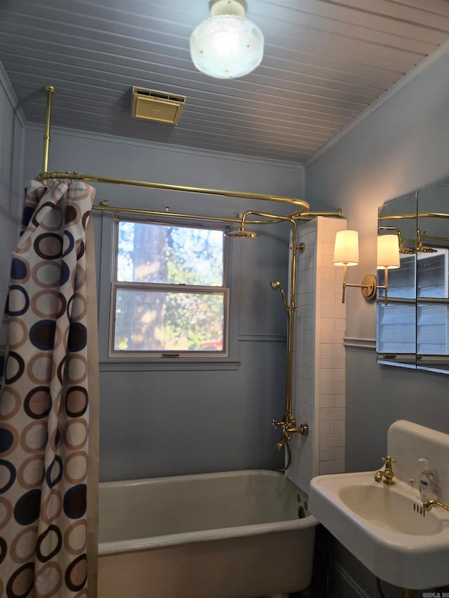 bathroom with shower / bath combo, crown molding, and sink