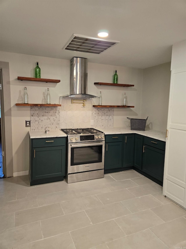 kitchen featuring wall chimney exhaust hood, light tile patterned floors, decorative backsplash, and stainless steel range