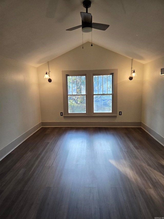 spare room featuring ceiling fan, dark hardwood / wood-style flooring, and lofted ceiling