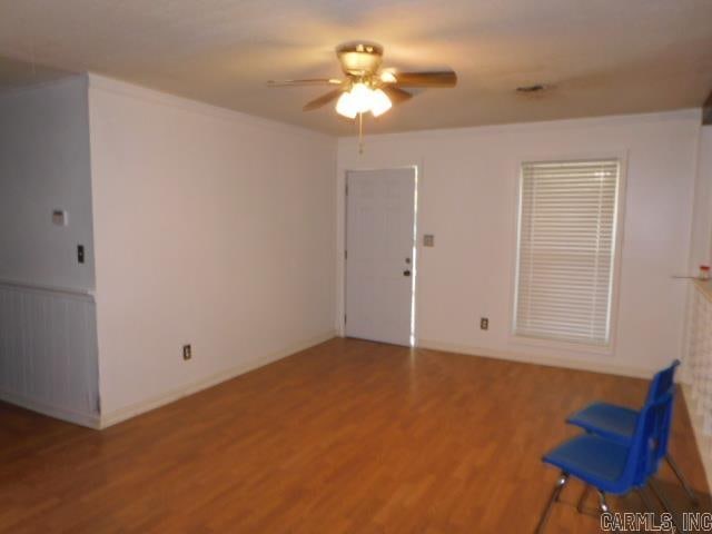 spare room with hardwood / wood-style floors and ceiling fan